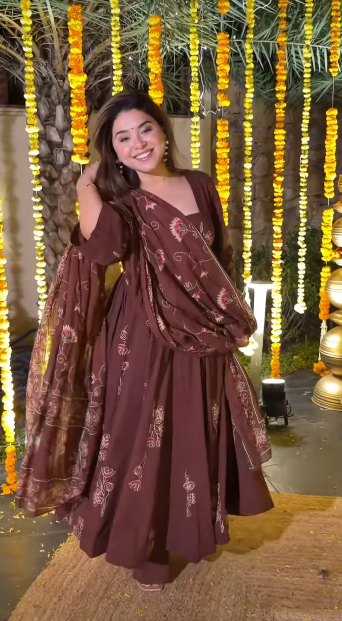 Woman in Brown Traditional Dress at Festive Event